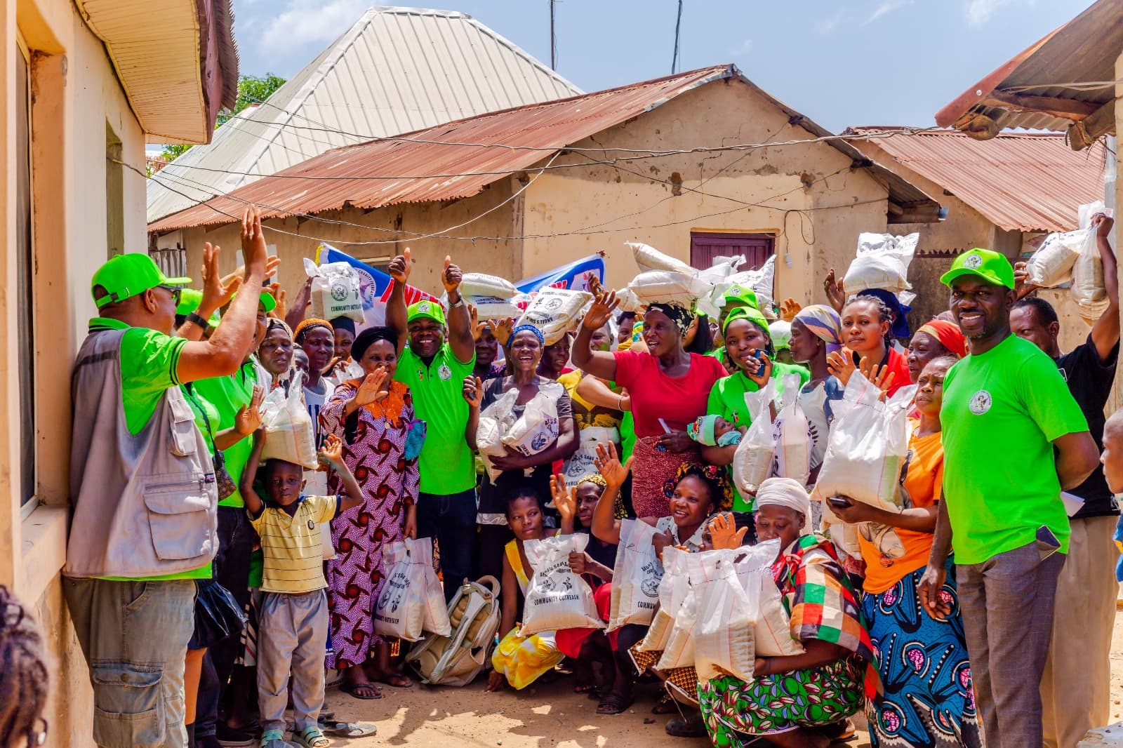 Families celebrating after receiving food supplies from Angel's Save a Soul Charity Foundation